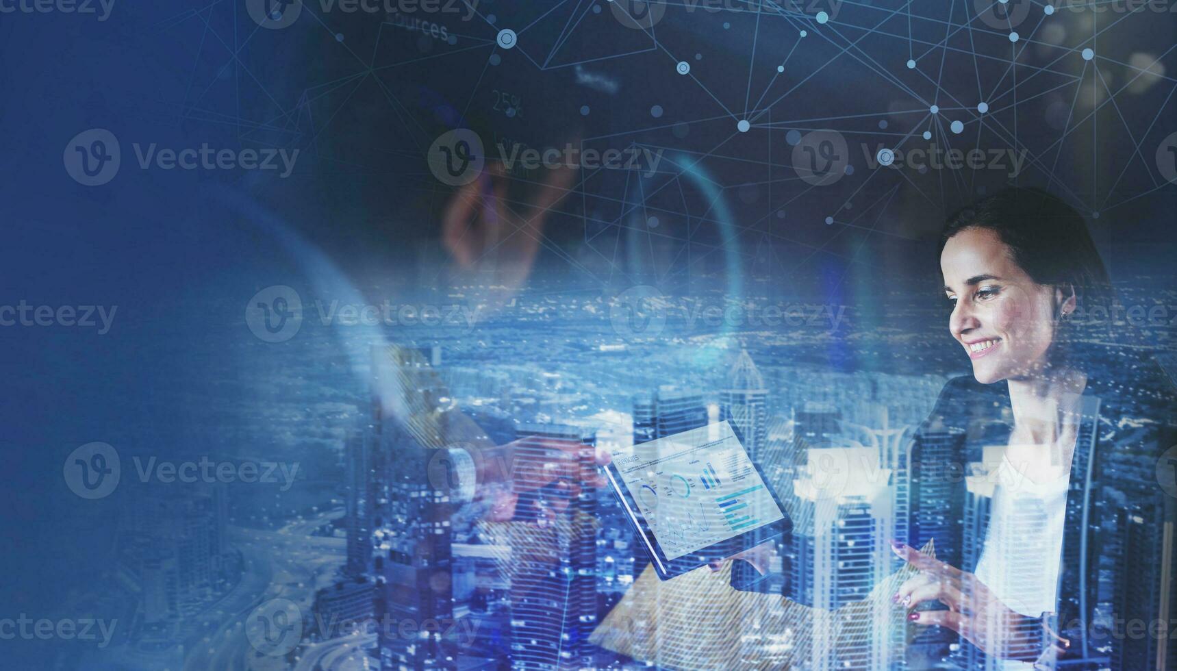 Abstract business background two caucasian people discussing a dashboard with charts and graphs with night cityscape overlayed over the picture photo