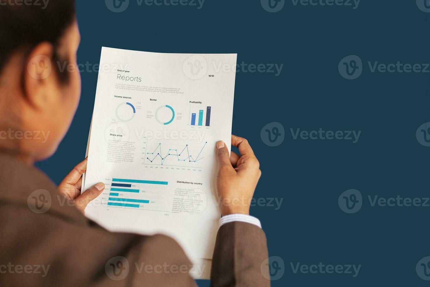 a woman in a business suit holding a piece of paper with graphs and diagrams photo
