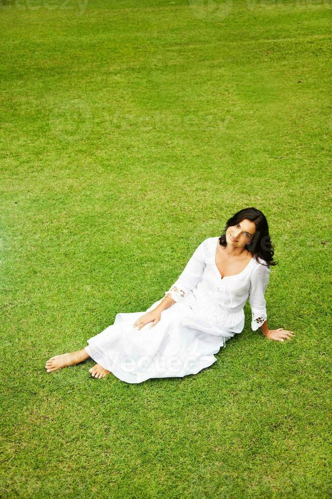 Beautiful woman on the grass photo