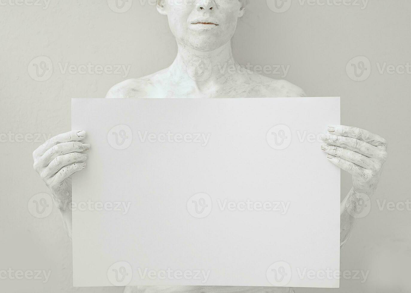 Blank design poster template. Woman covered with white paint holding  a paper. Focus on hands. photo