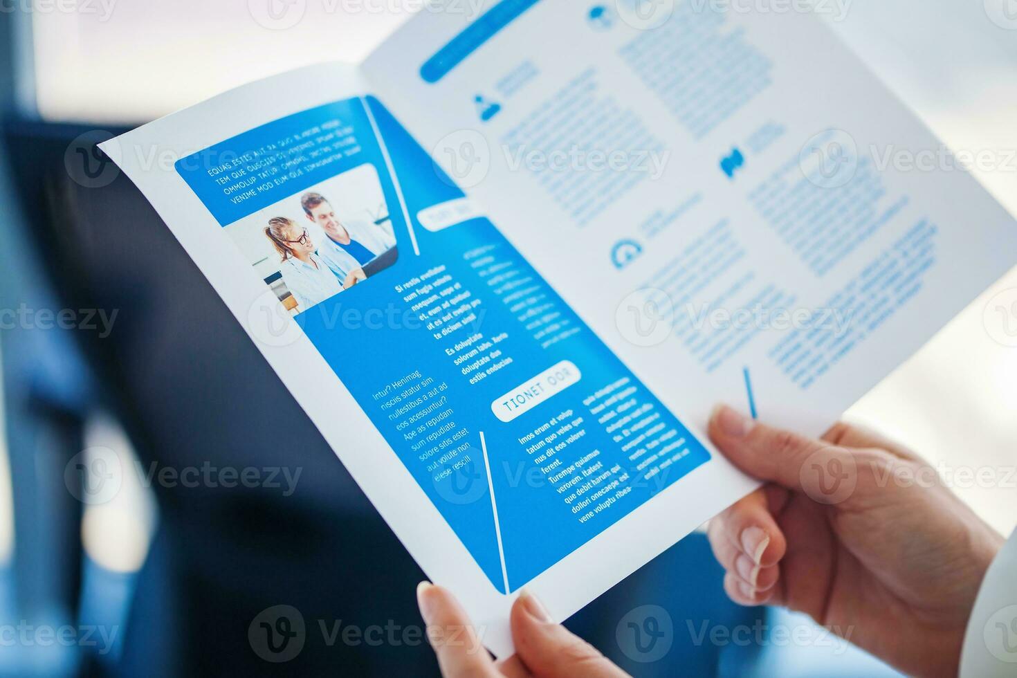Hands holding a business pamphlet photo