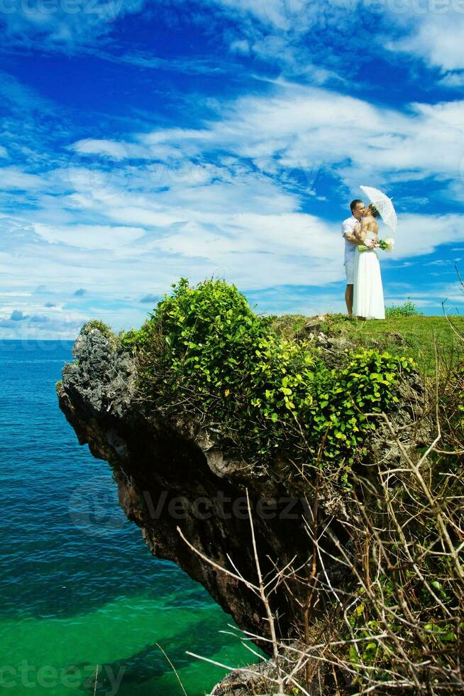 Newly married couple on the beach. Wedding and honey moon concept photo