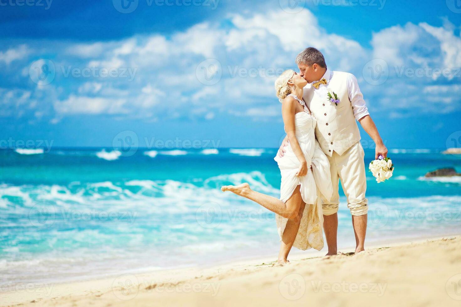 Newly married couple on the beach photo