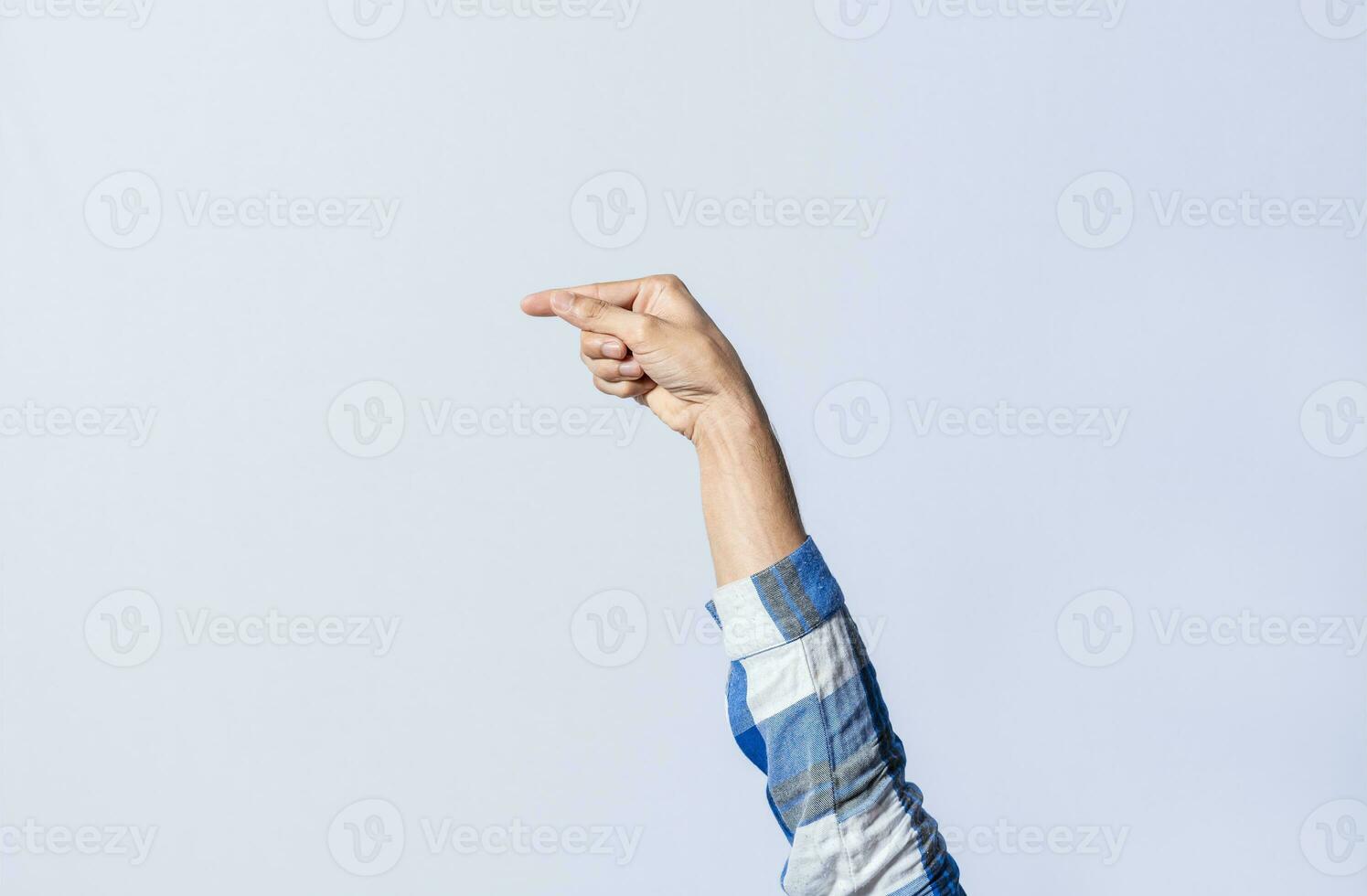 Hand gesturing the letter G in sign language on an isolated background. Man's hand gesturing the letter G of the alphabet isolated. Letters of the alphabet in sign language photo