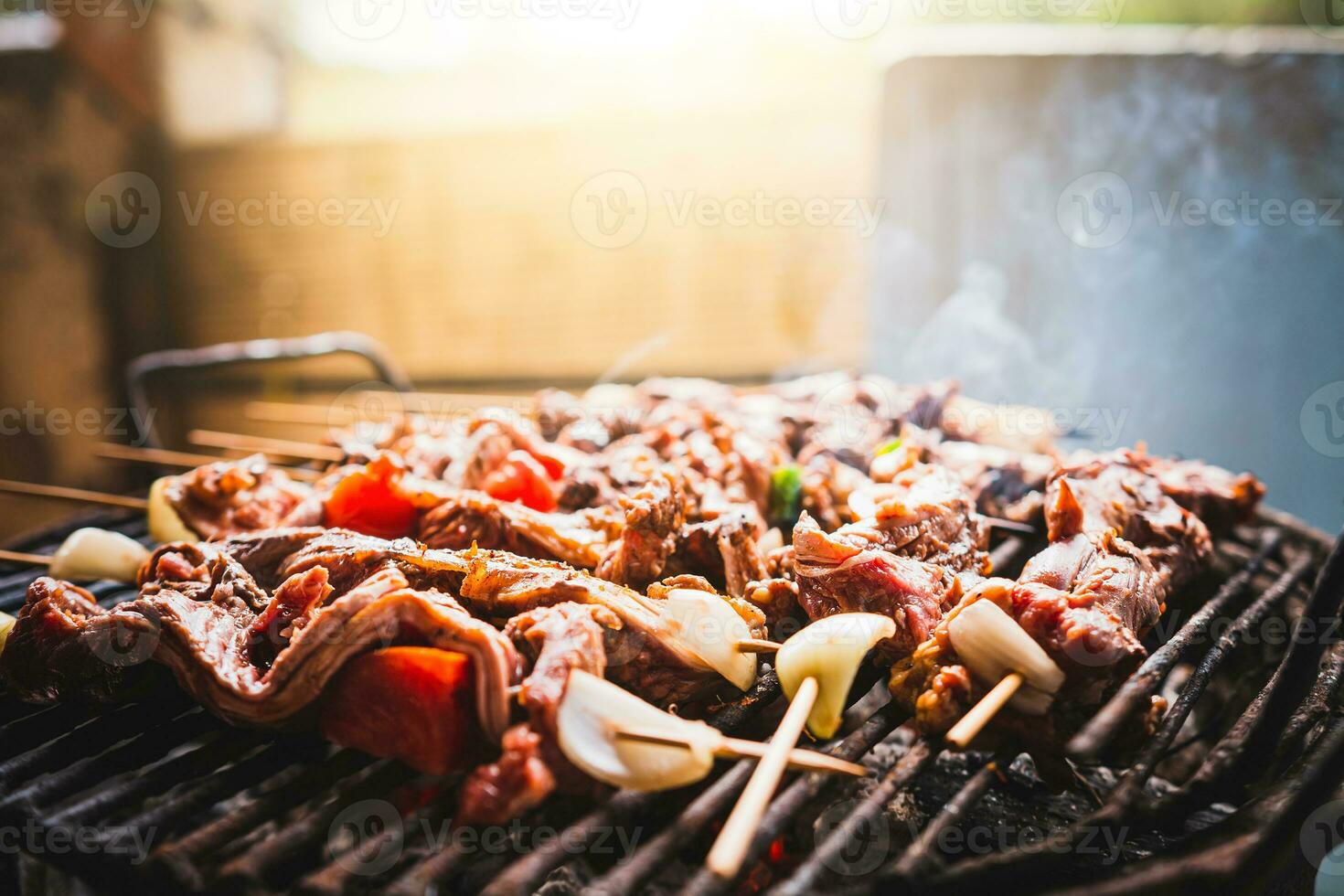 Charcoal roasted meat skewers. Homemade roast meat skewers on charcoal grill. Top view of meat roasted on a grill photo