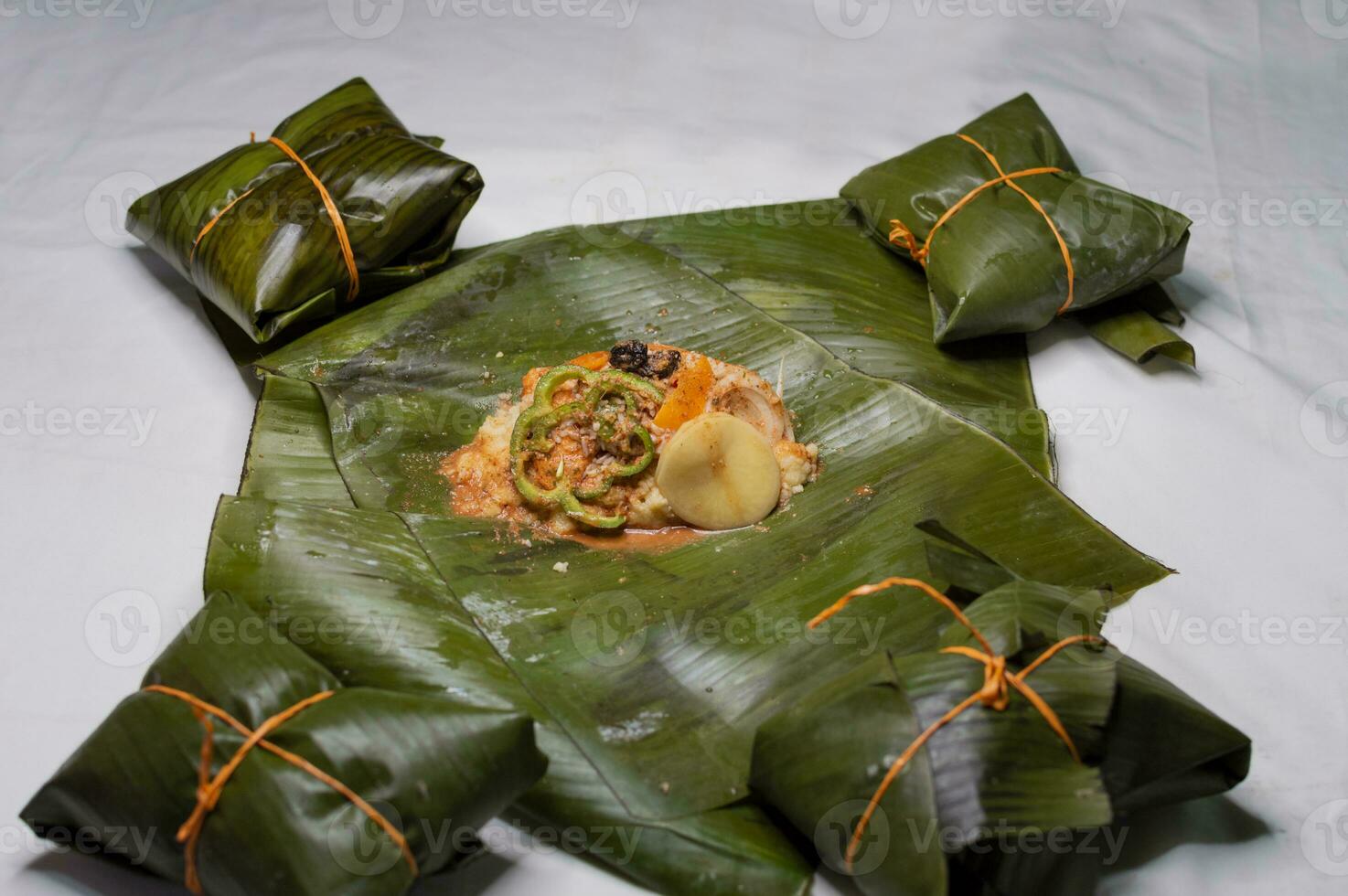 Top View of raw ingredients of the Nicaraguan nacatamal on banana leaves. Raw ingredients for the preparation of the traditional Nacatamal, Nacatamal ingredients on banana leaves photo