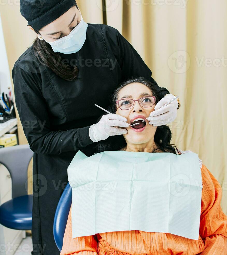 Dentist performing dental checkup, Patient checked by dentist, close up of dentist with patient, dentist performing root canal treatment on patient photo