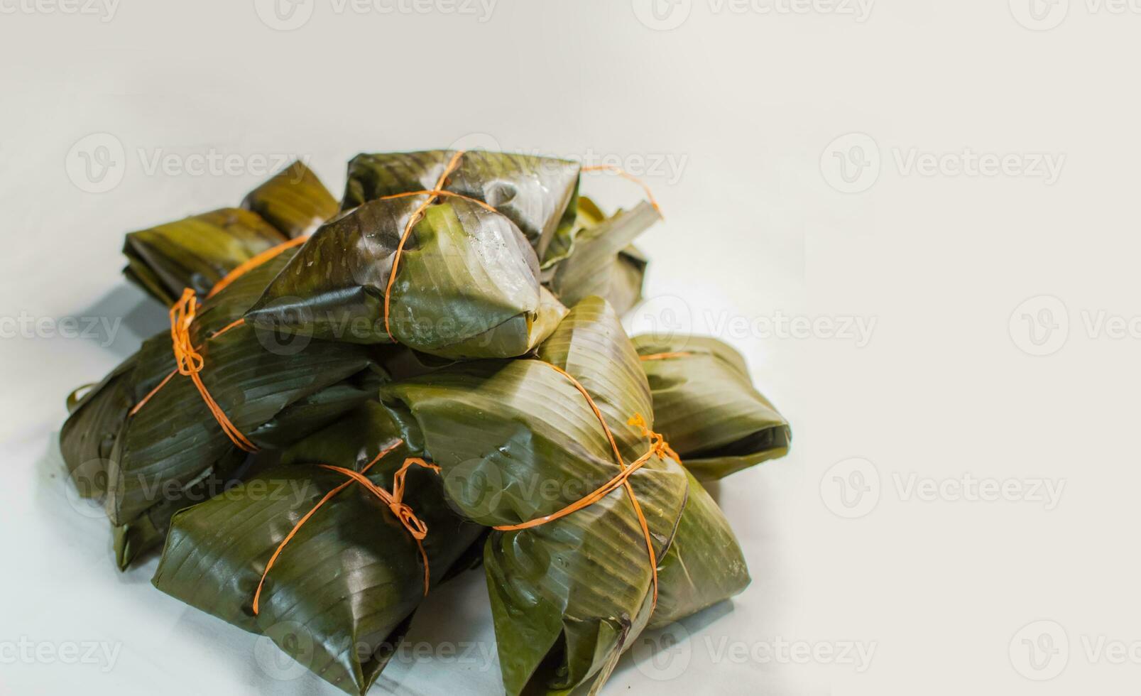 Traditional Nacatamales in banana leaves isolated, View of homemade nacatamales with banana leaf on white background, Traditional Mexican Nacatamales food on isolated background photo