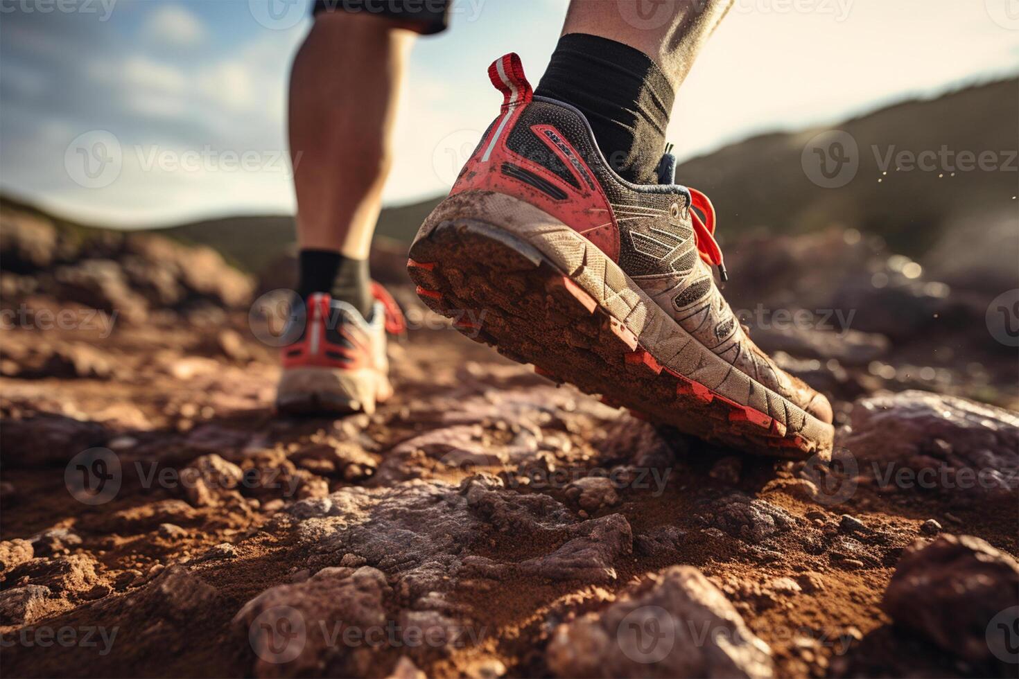 Closeup of man trail running on rocky terrain photo