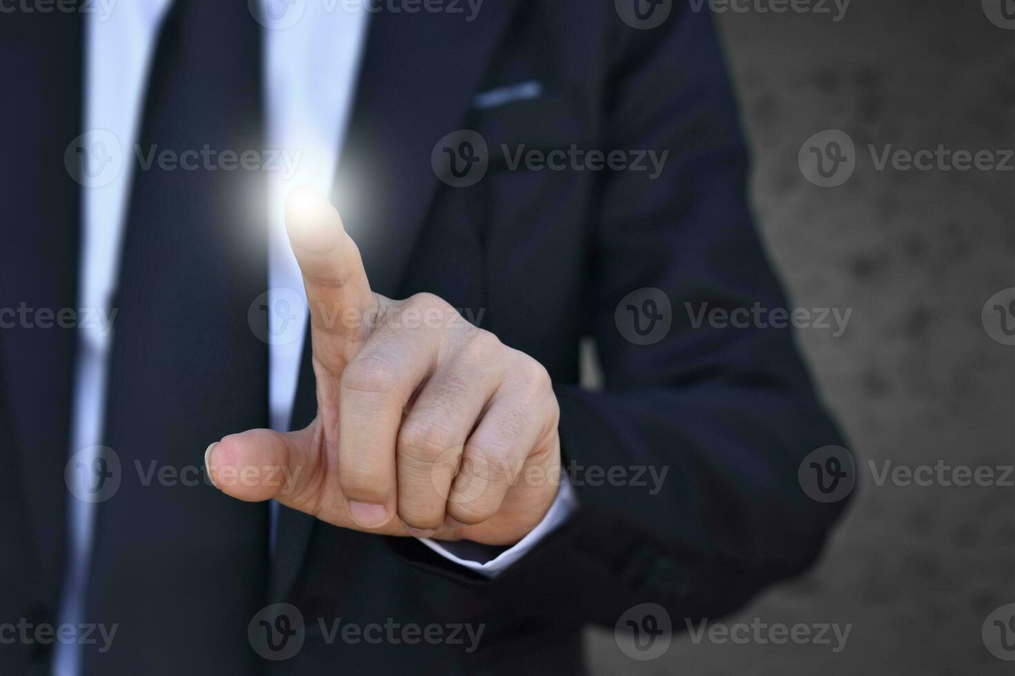 Businessman finger pressing an imaginary screen. Idea for business, technology, internet and networking. photo