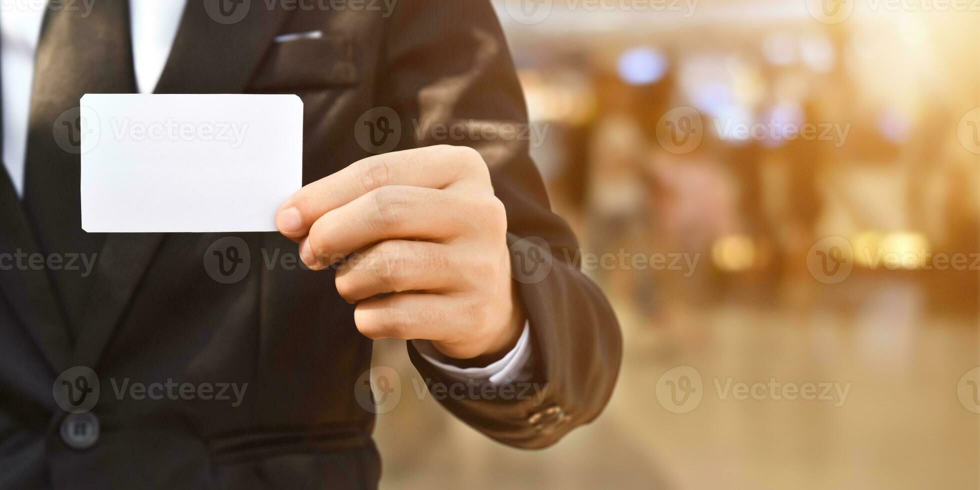 Businessman showing a blank piece of paper. Any business cards design ideas. photo