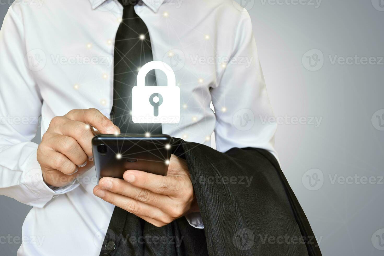 Businessman holding mobile phone with shield lock. Cyber security data protection and information technology network concept. photo