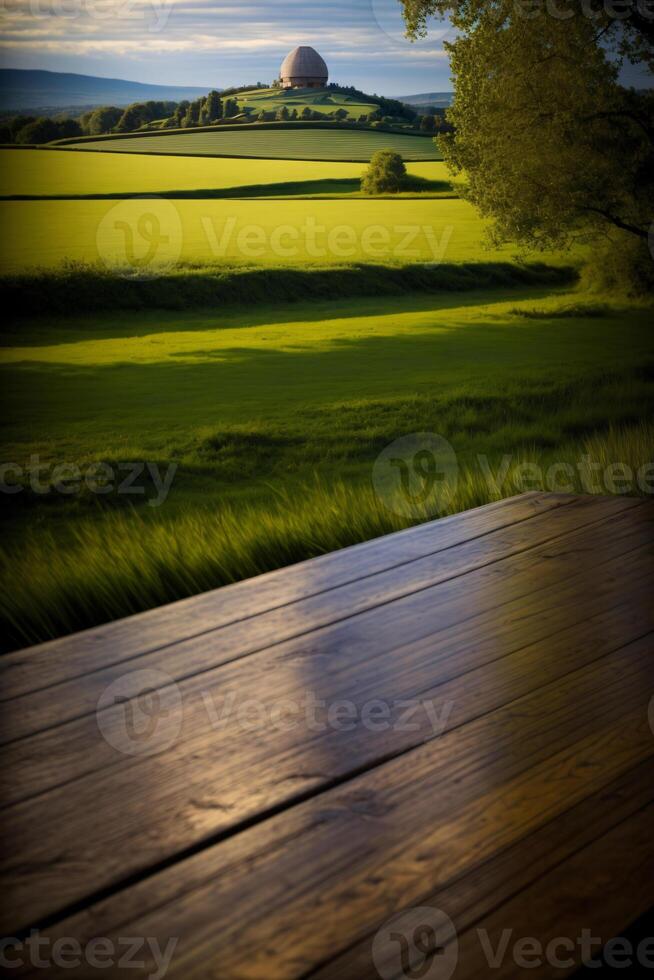 A Wooden Table Sitting On Top Of A Lush Green Field. photo