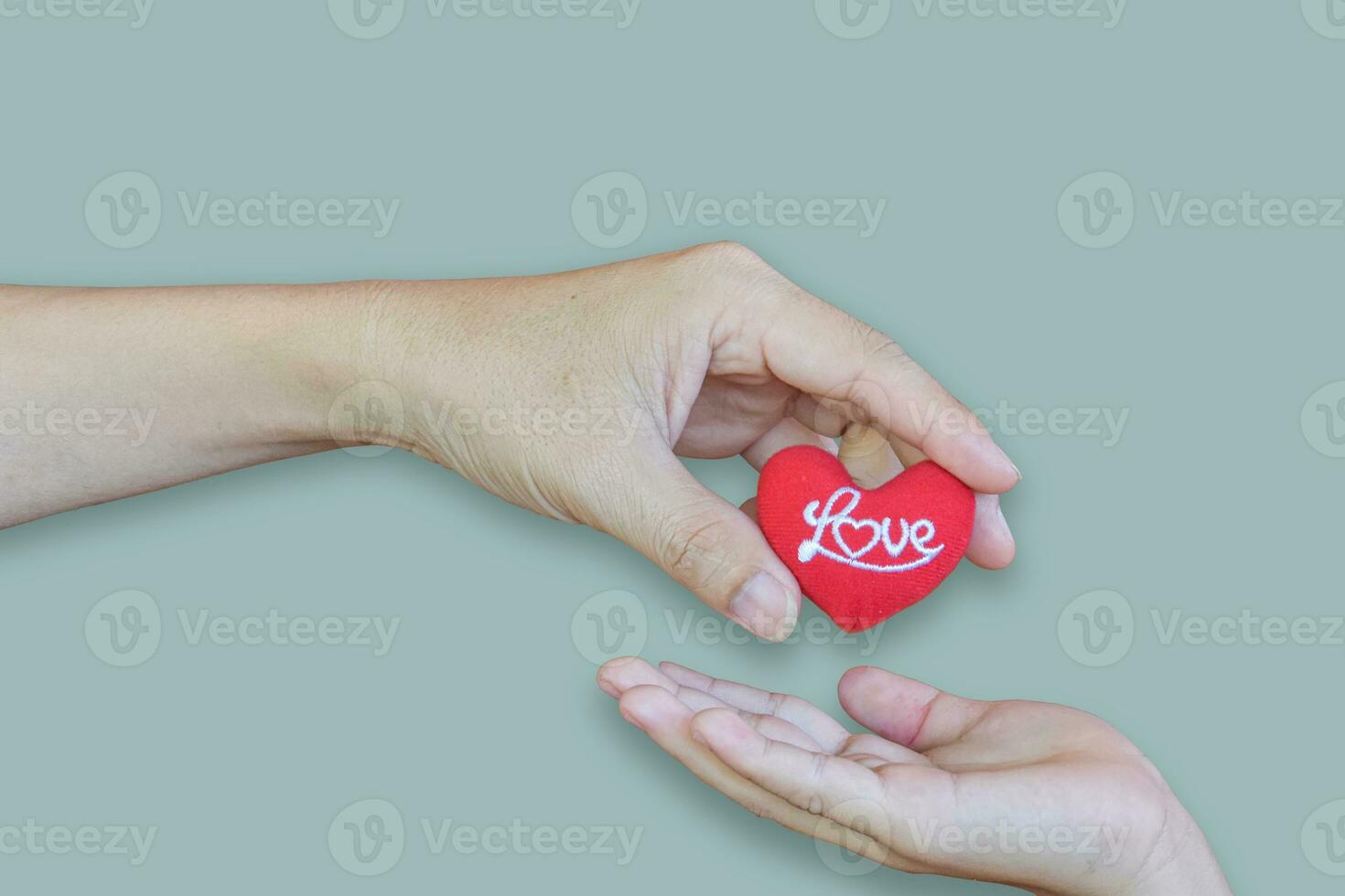Father giving heart symbol to daughter on blue background. love concept photo