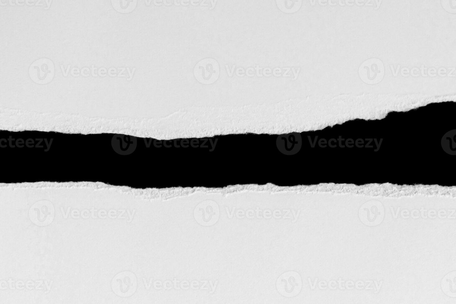 White ripped piece of paper isolated on black background with clipping path. photo