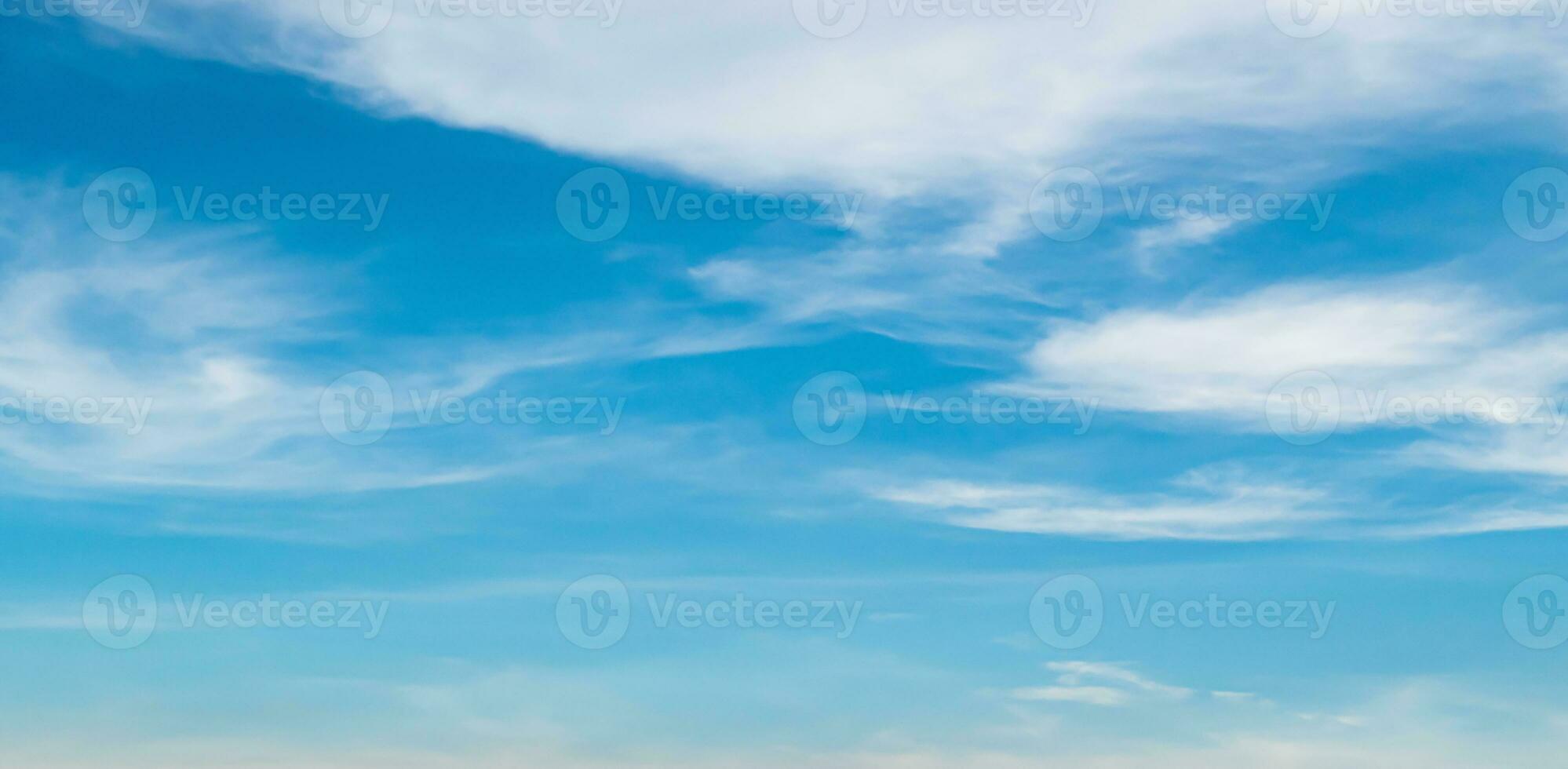 Blue sky against soft white clouds. Beautiful natural cloudscape background. photo
