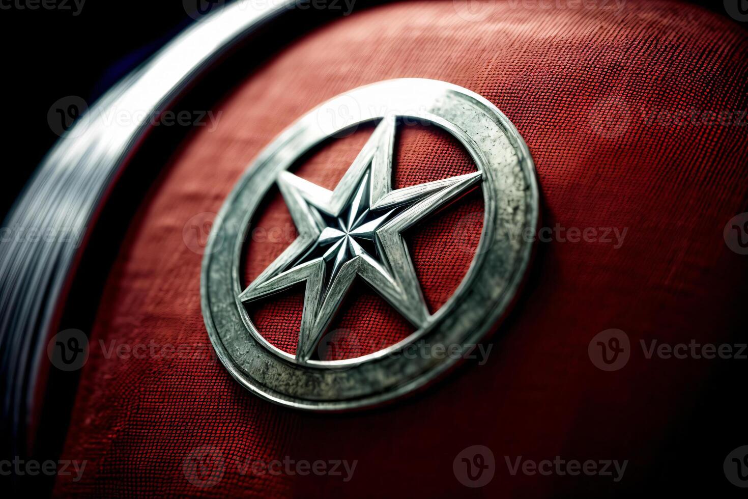 A Close Up Of A Metal Star On A Red Cloth. photo