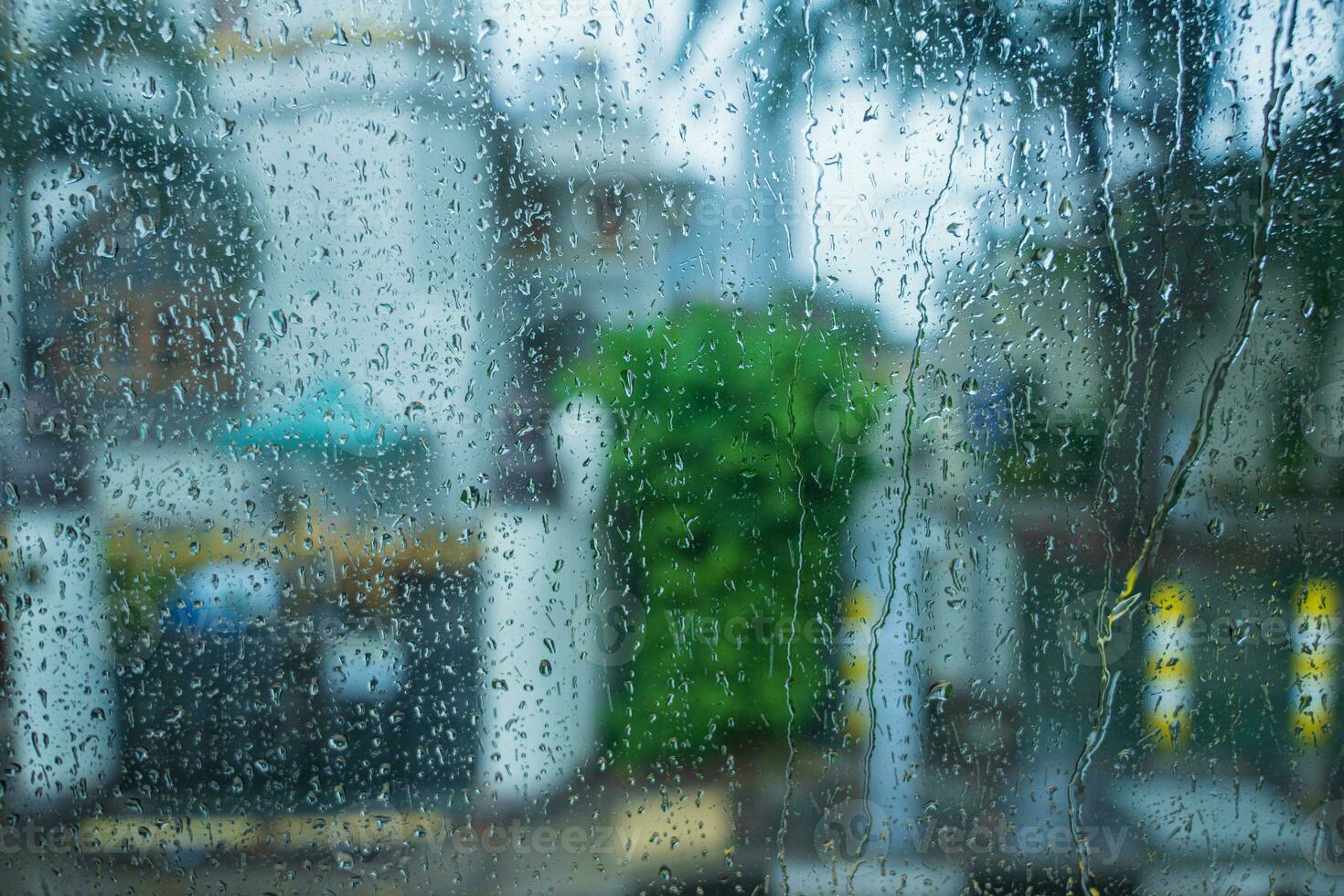 Raindrops on glass mirror background. water drop on a window photo