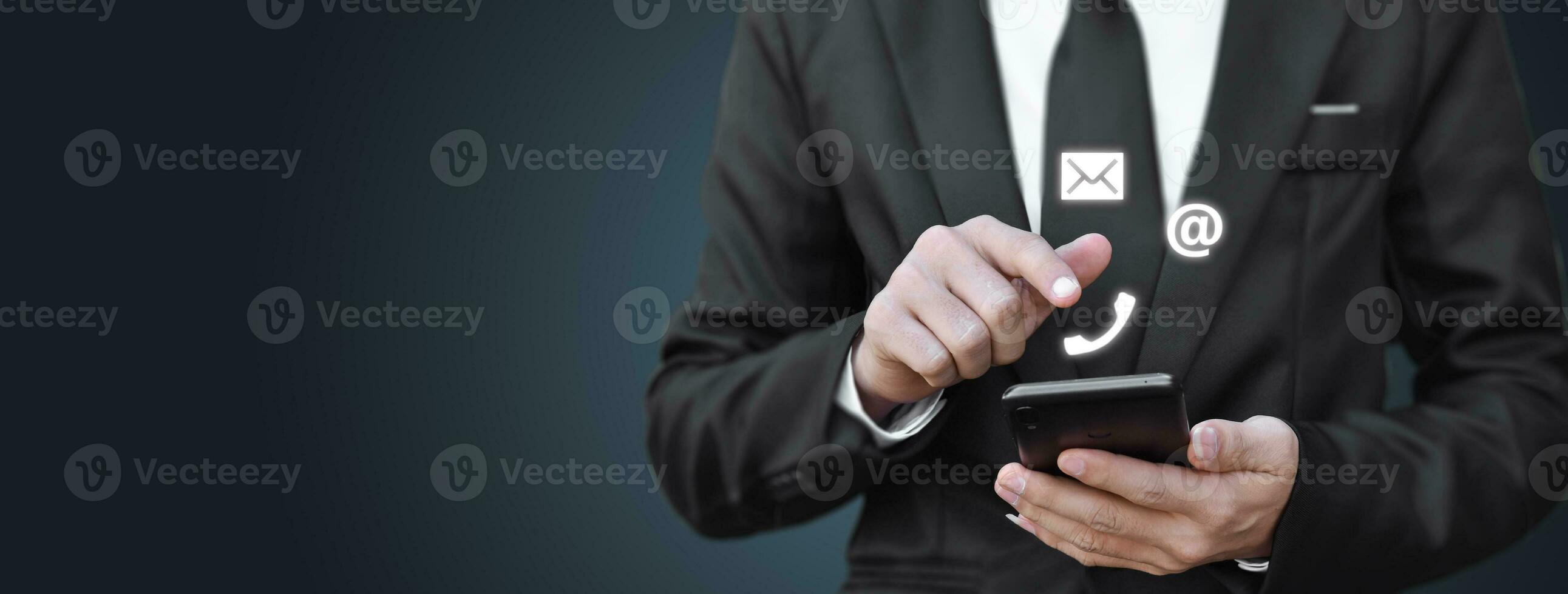 Businessman hand holding smartphone with icon mobile phone, and email address. Concept of customer service call center contact. contacting information on business. Copy space. photo