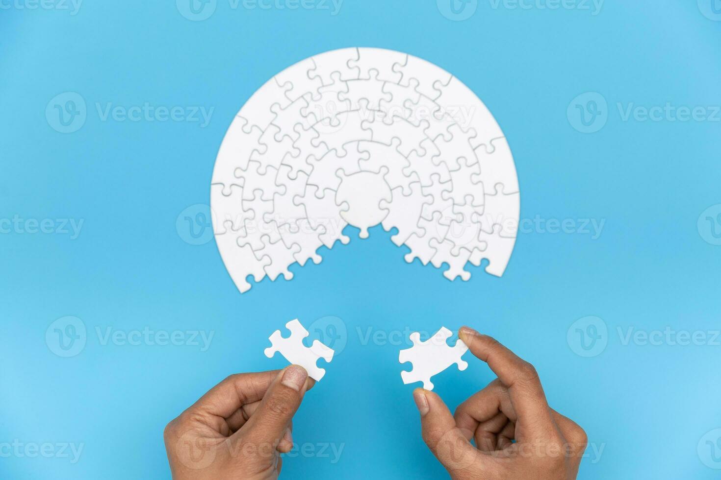 Two hands of businessman to connect couple puzzle piece. symbol of association and connection. business strategy. photo