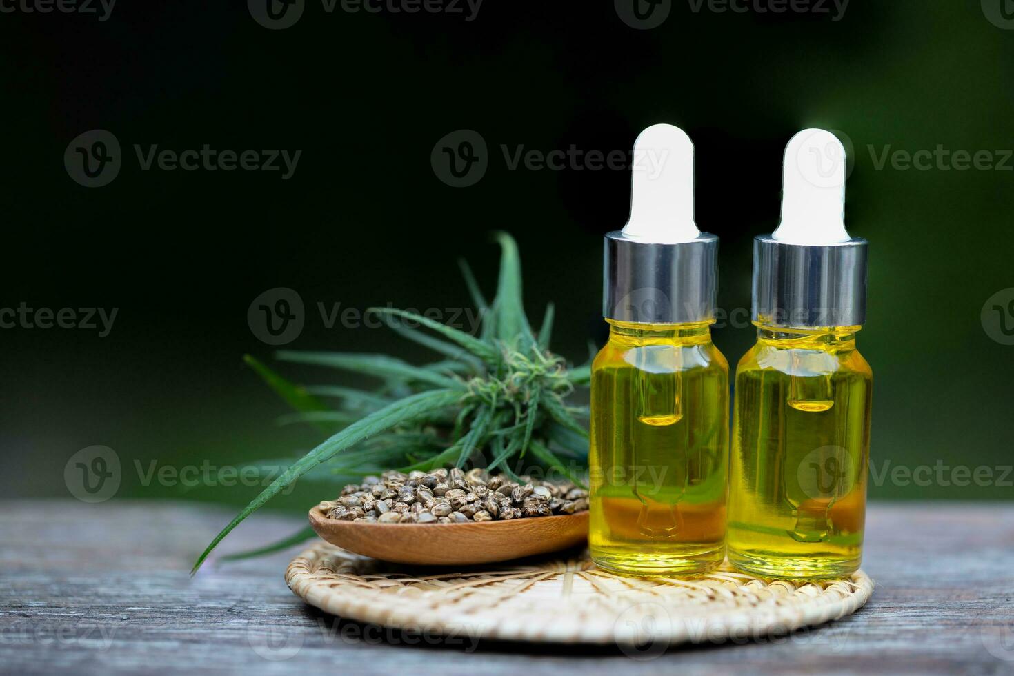 Cannabis seeds and CBD oil cannabis extract, green hemp leaf background, Medical cannabis concept. photo