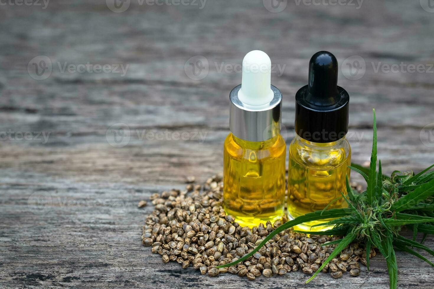 Hemp oil and hemp seeds on a wooden table, Medical marijuana products including cannabis leaf, cbd and hash oil, alternative remedy or medication,medicine concept. photo