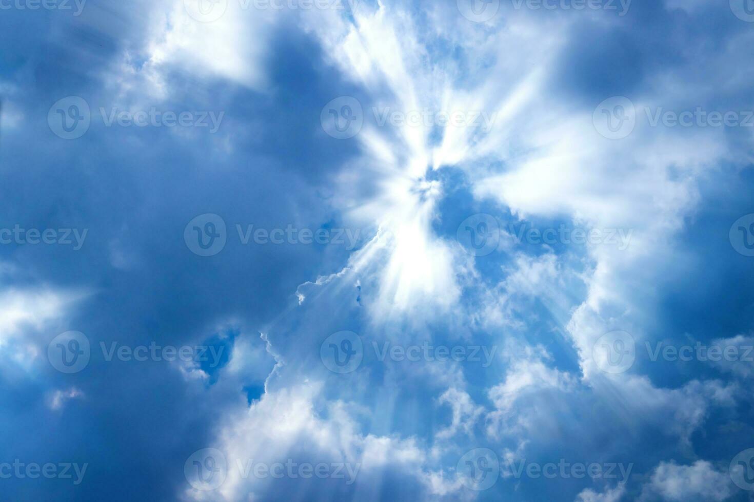 Sunbeam through the cloud on blue sky photo