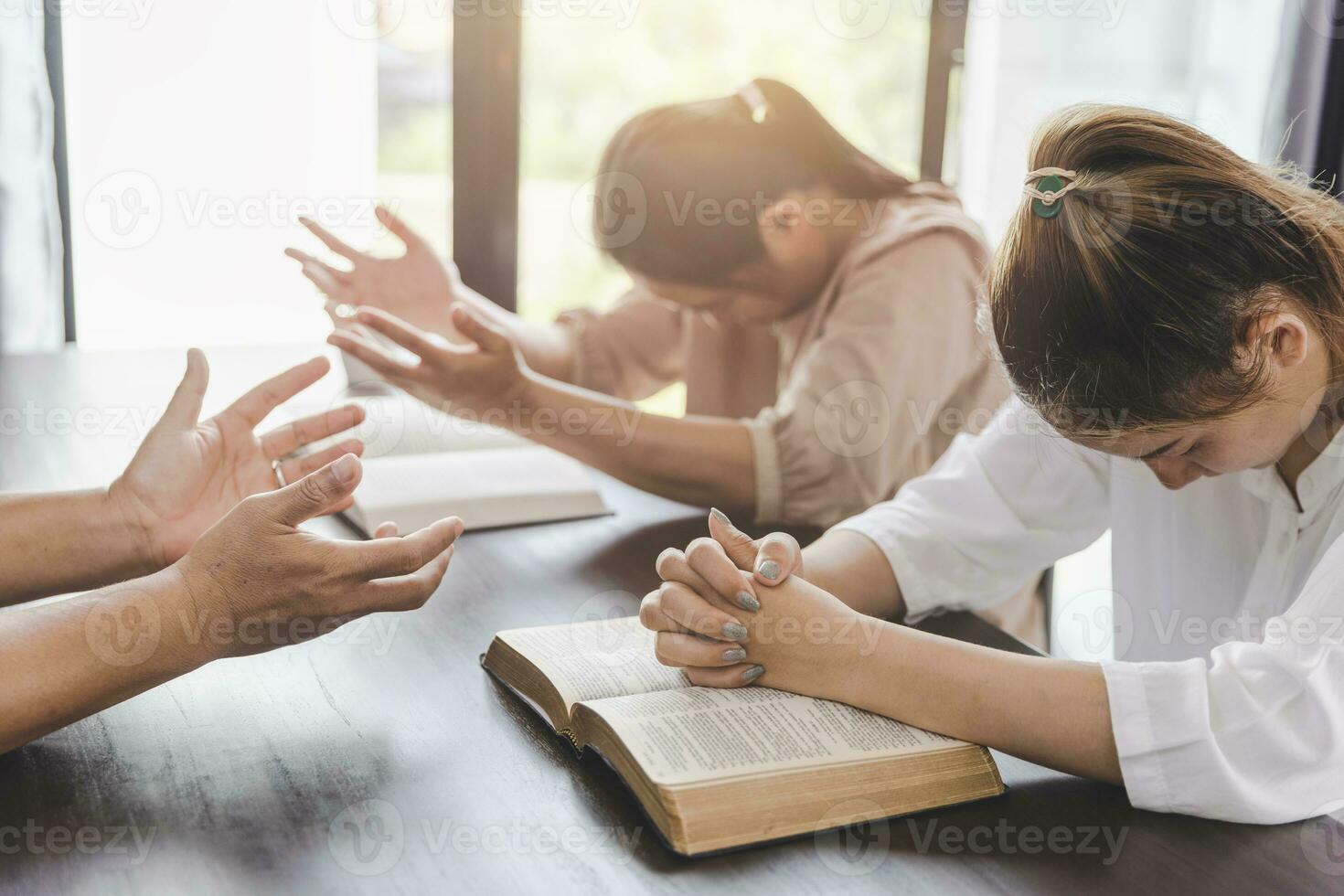 pray together to the Lord on the table with the bible concept of believing in God May God give you hope to overcome obstacles. Home church, devotion or prayer, religious concept. photo