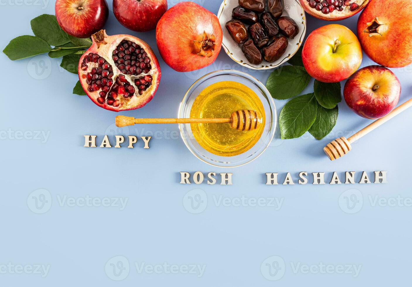 Beautiful background for the new Jewish New Year. traditional products on a blue background with wooden letters Rosh Hashanah. Top view photo