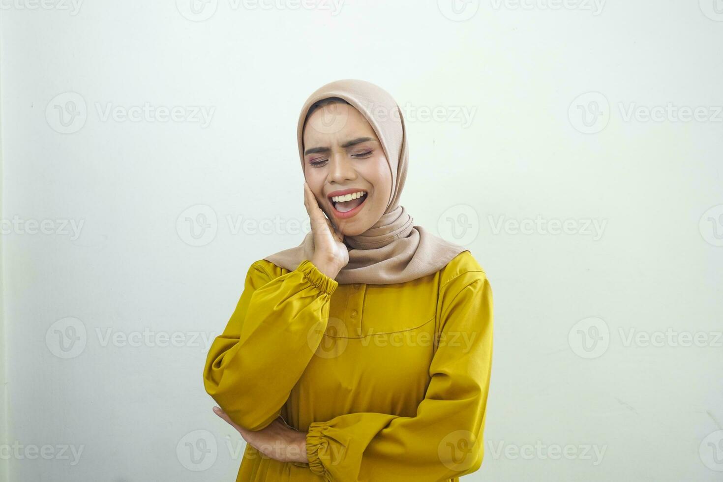 Cheerful young Asian woman in yellow dress isolated on white background photo