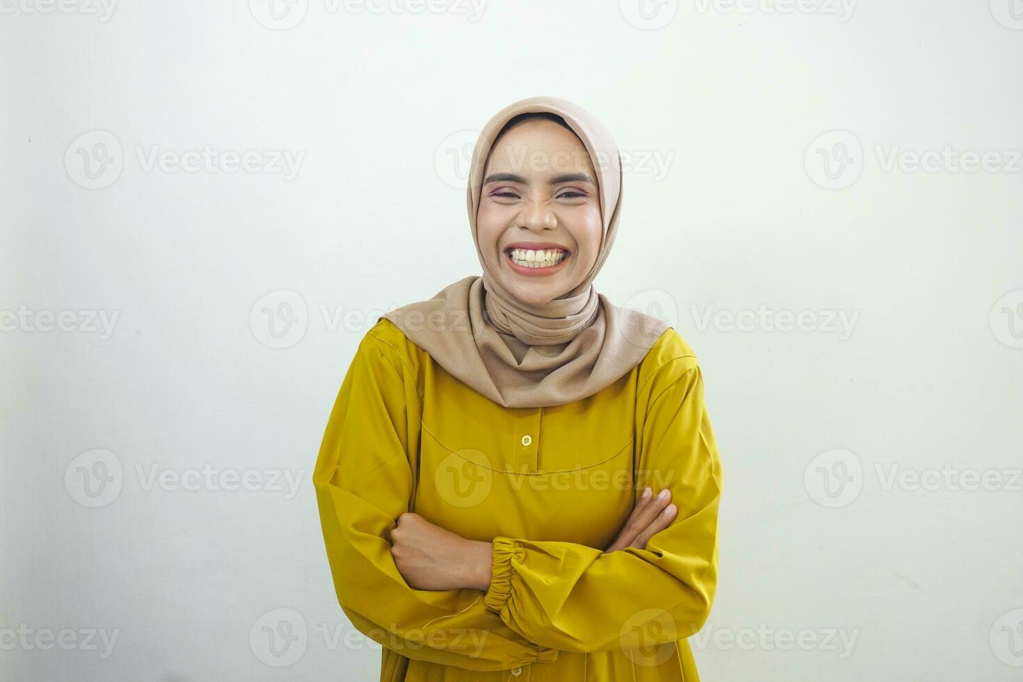 Laughing young Asian Muslim woman feeling funny chatting isolated over white background photo