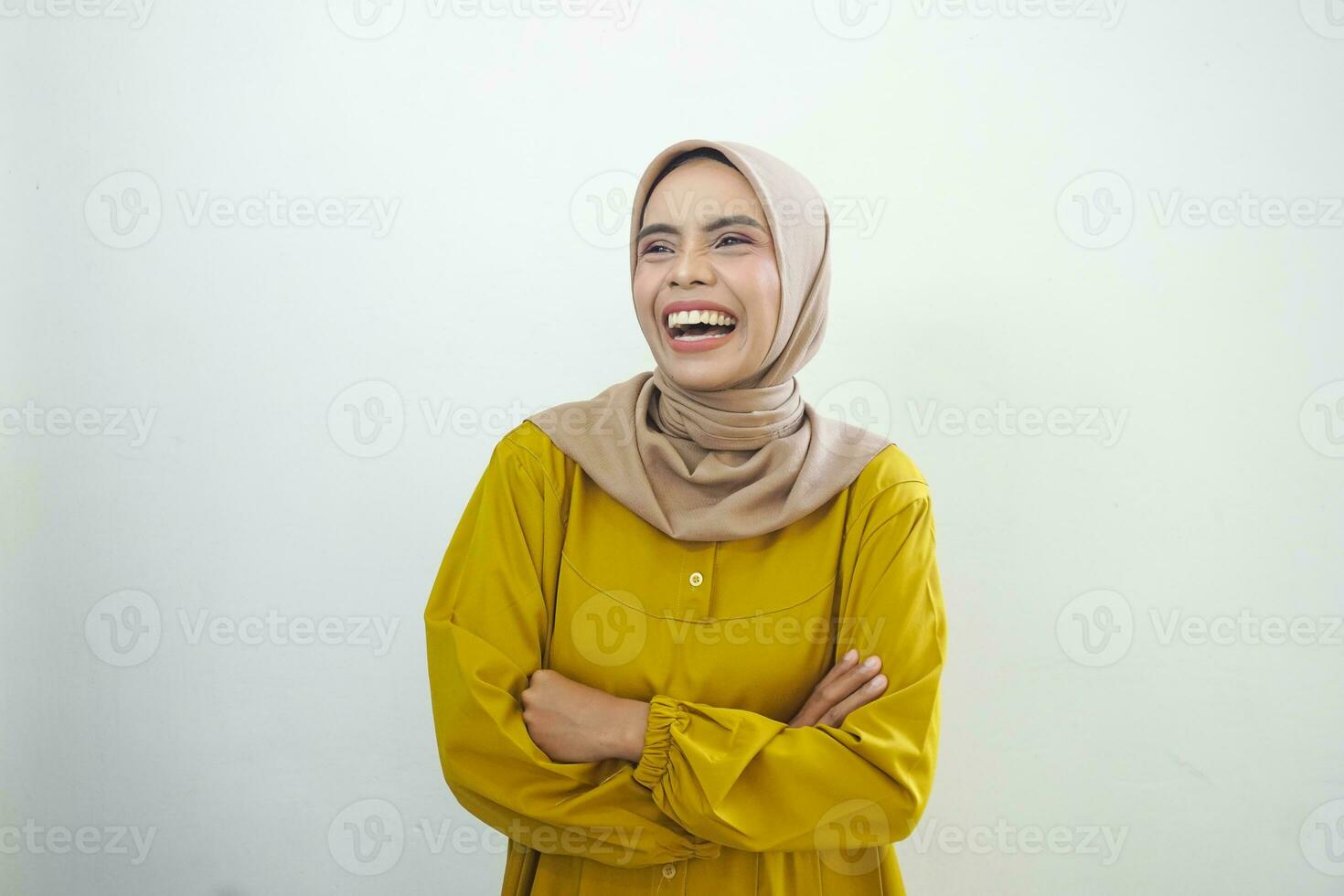 Laughing young Asian Muslim woman feeling funny chatting isolated over white background photo