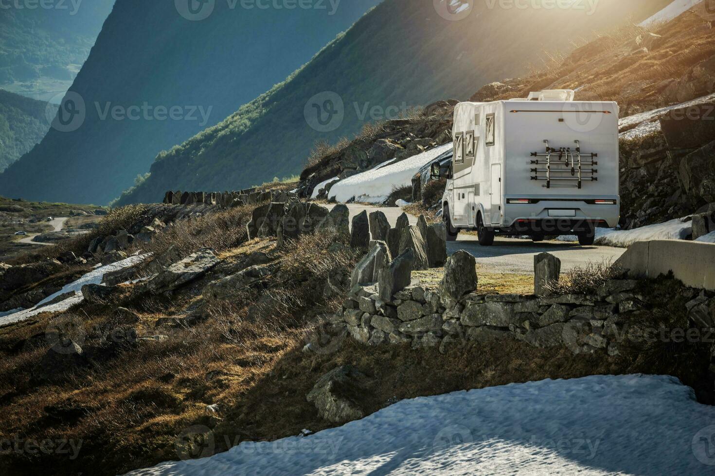 RV Camper Van on a Scenic Mountain Road Somewhere in the Norway. photo