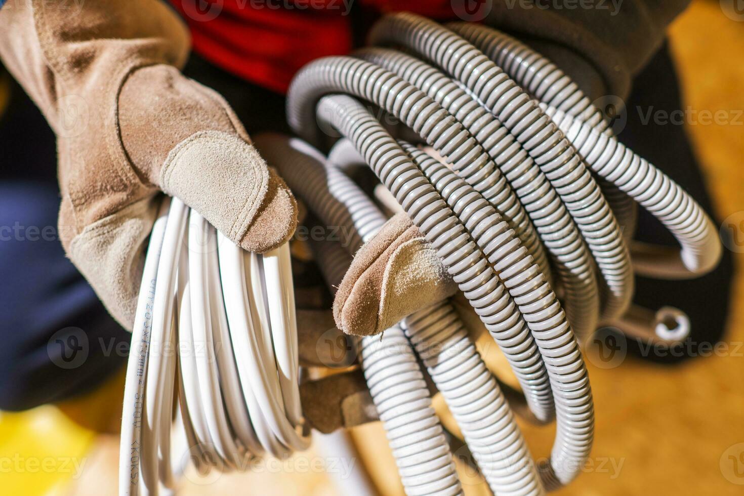 Electrician with Plastic Electric System Conduits in His Hands photo