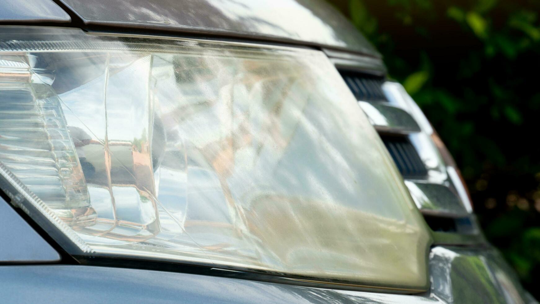 Side of front gray car close up on car headlights. Parking in the parking lot. photo