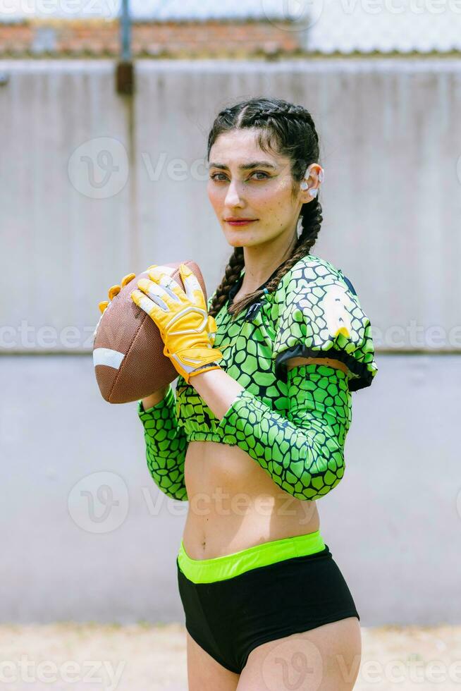 Portrait of mexican woman american football player wearing uniform with velociraptor skin patterns photo