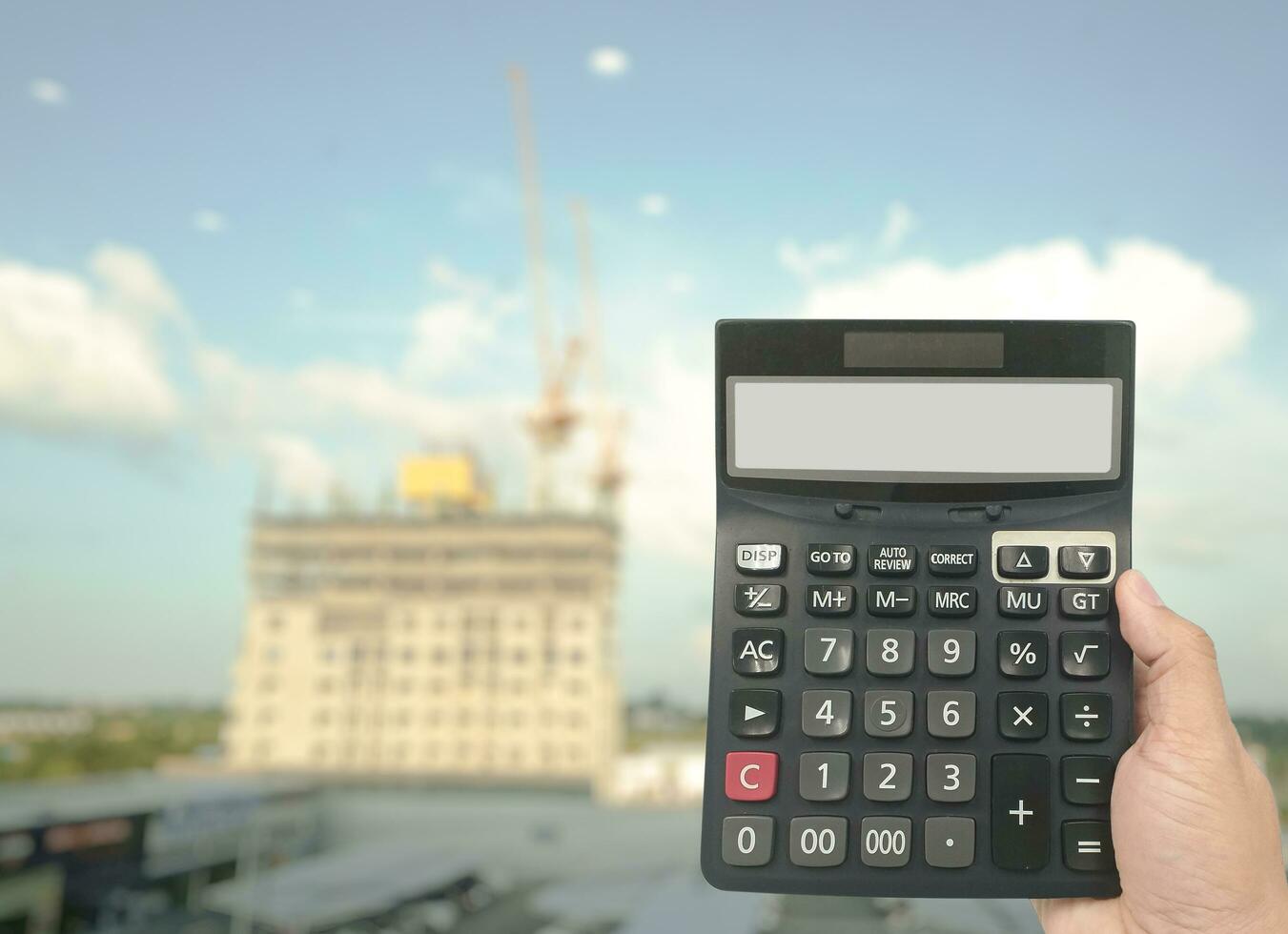 Businessmen hold a calculator to calculate the construction cost of a condo and the income from building a residence. Concept of finance and construction photo