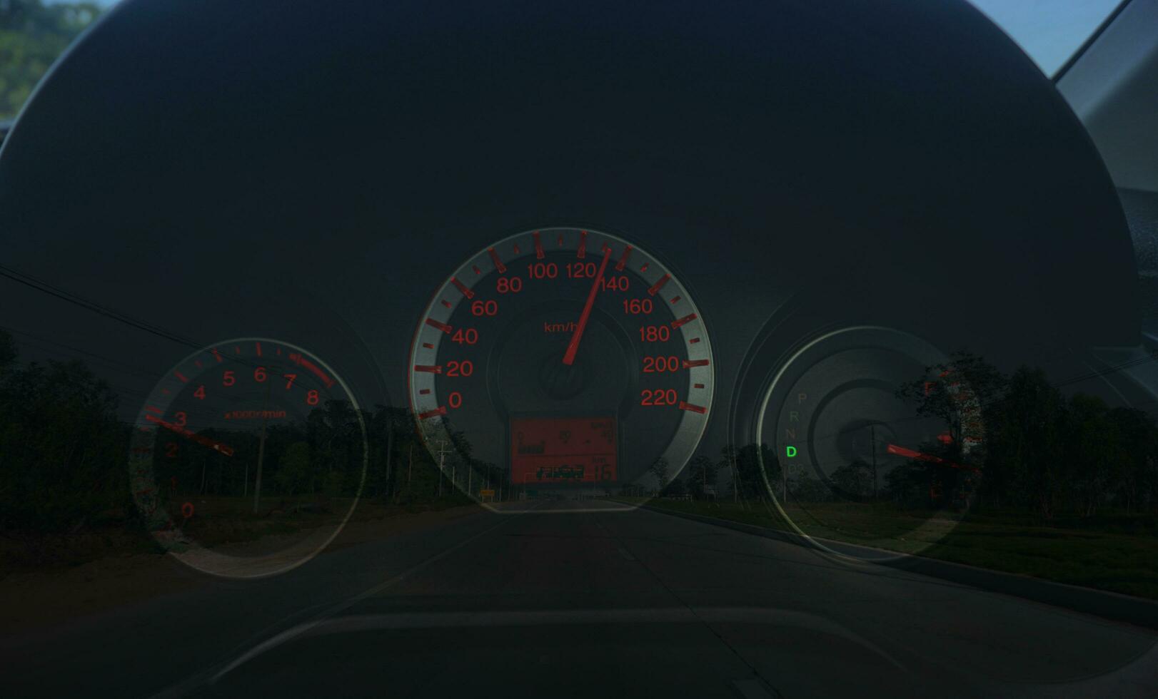 Speedometer 110 kilometre over a blurred road representing driving very fast Evening background. photo