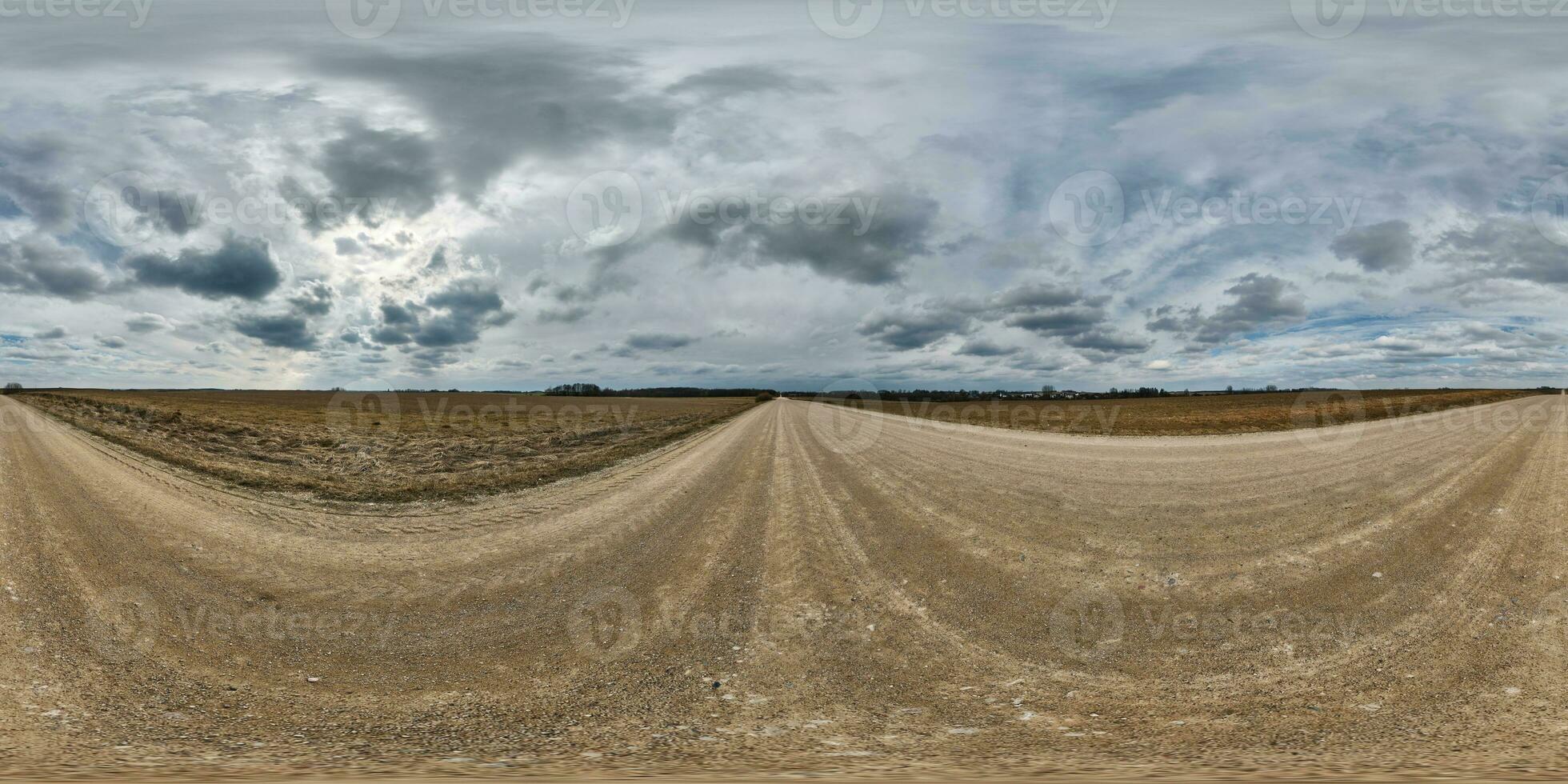 gravel road with clouds on overcast sky as spherical 360 hdri panorama in equirectangular seamless projection, use as sky dome  replacement in drone panoramas, game development as skybox or VR content photo