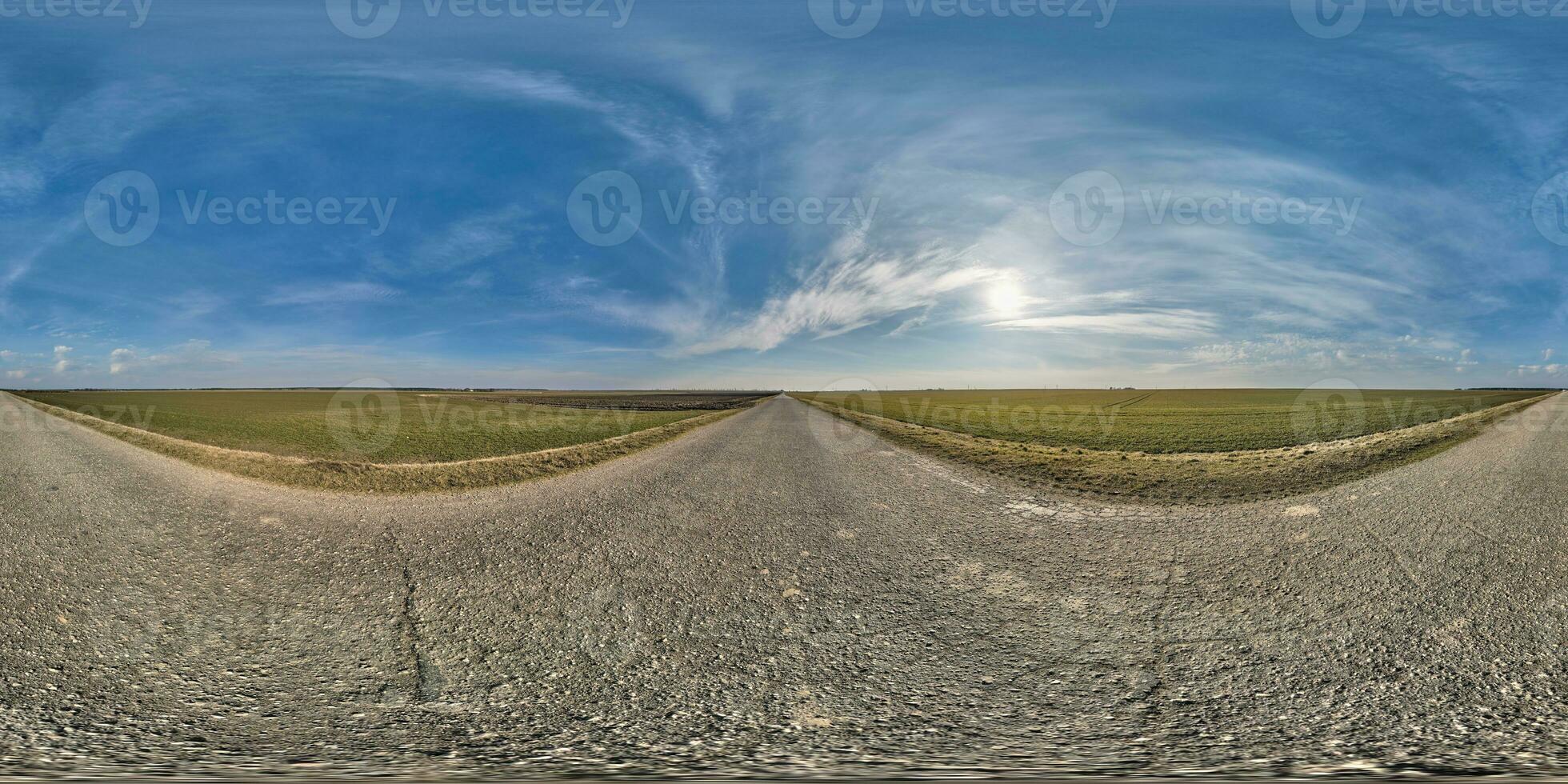 spherical 360 hdri panorama on old asphalt road with cracks with clouds and sun on blue sky in equirectangular seamless projection, as sky replacement in drone panoramas, skybox game development photo