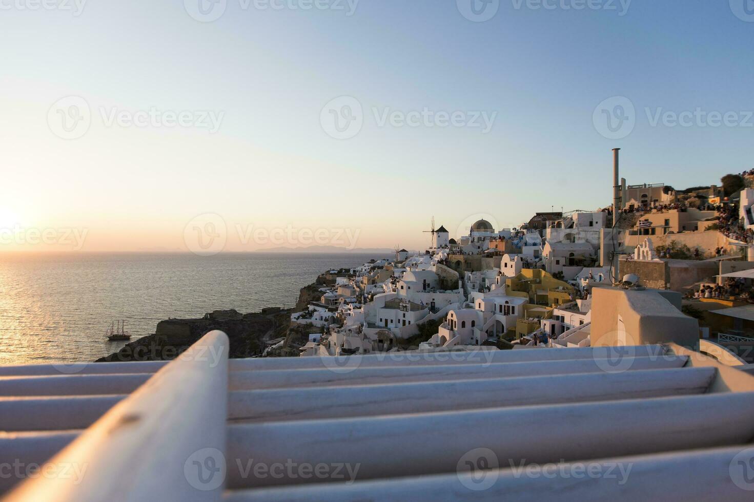 Oia village on Santorini island in Greece at sunset photo