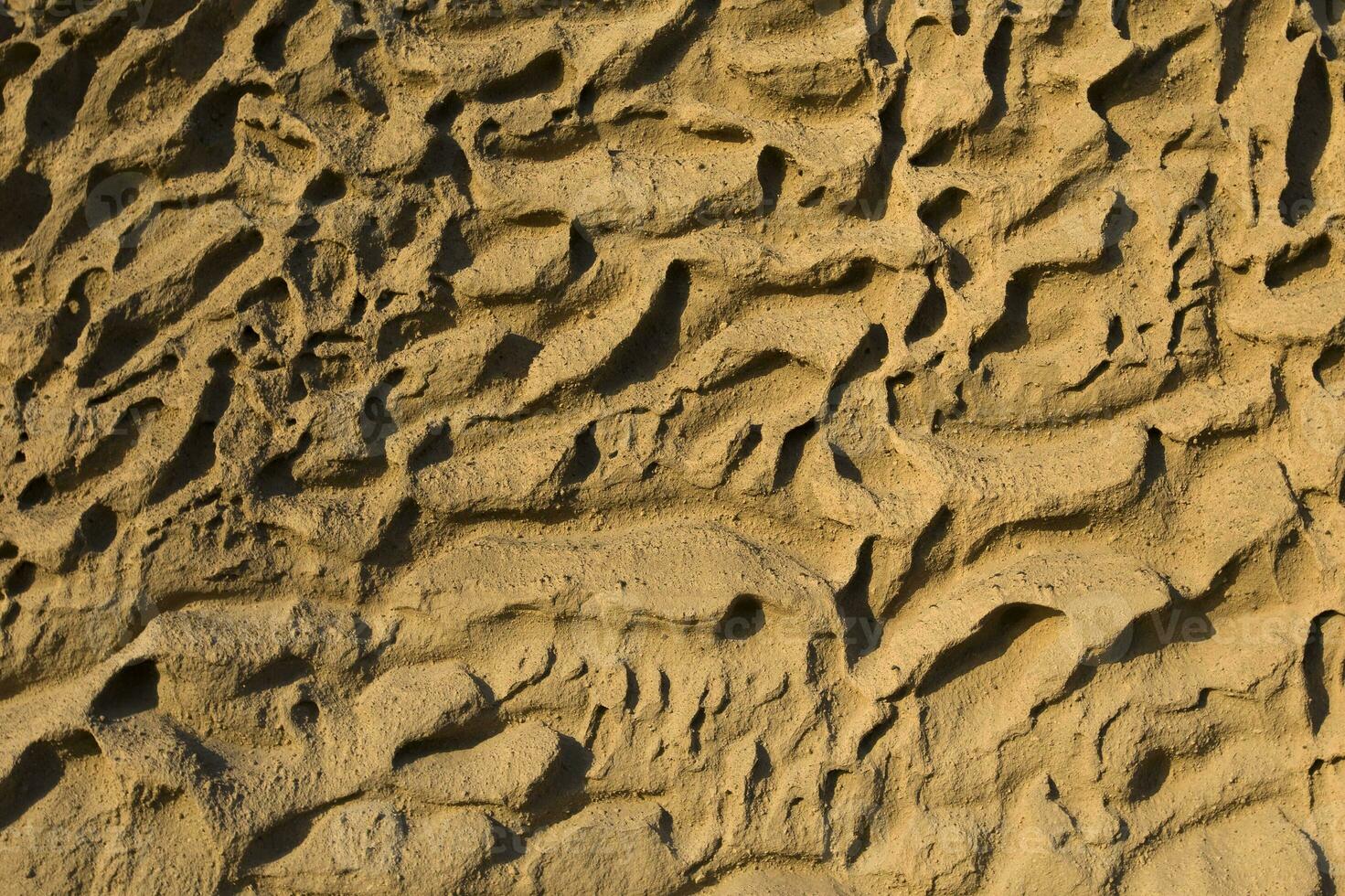 Closeup of Vlychada beach volcanic ash sand rock formation on Santorini island in Greece photo
