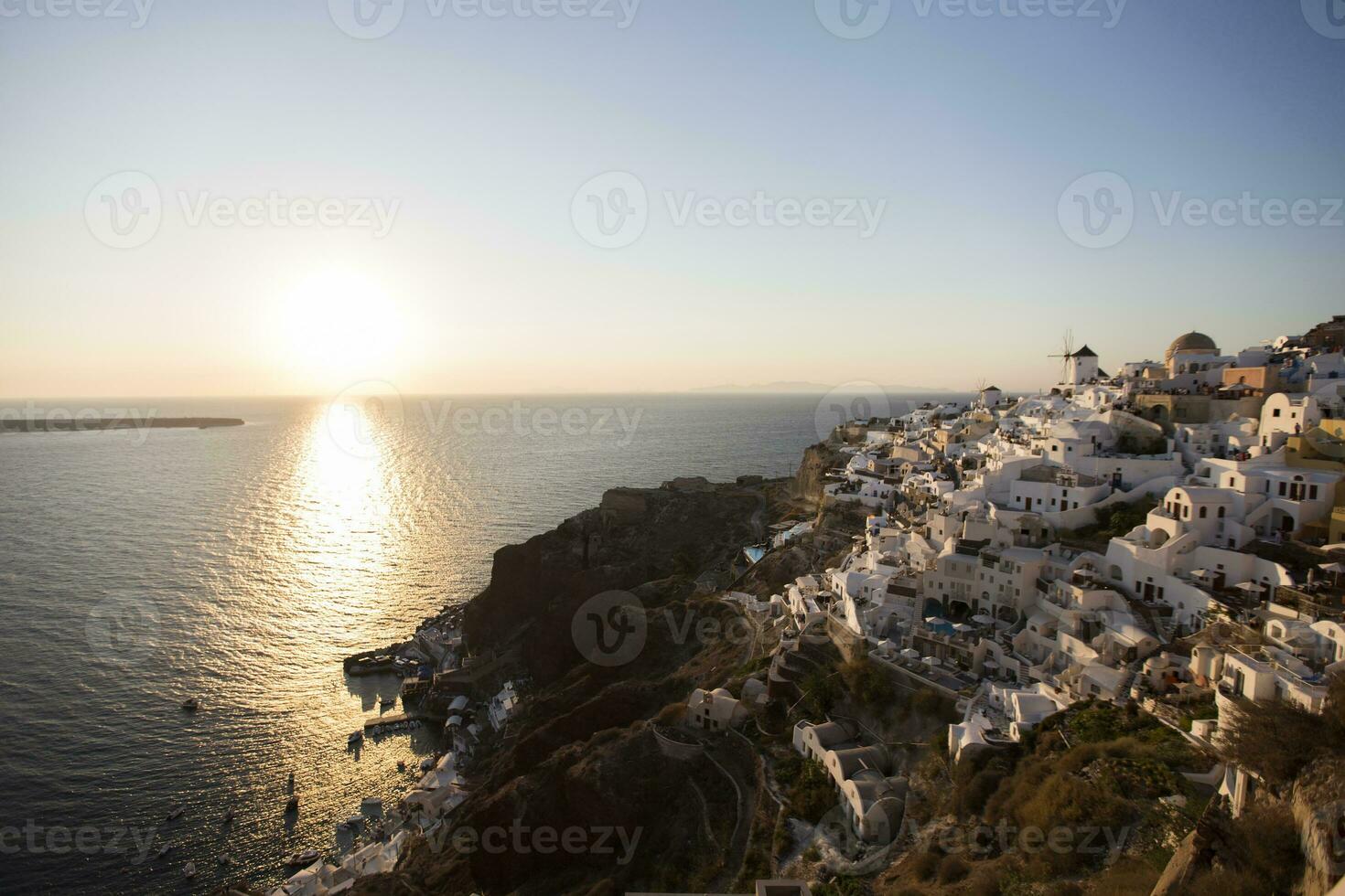 Oia village on Santorini island in Greece at sunset photo