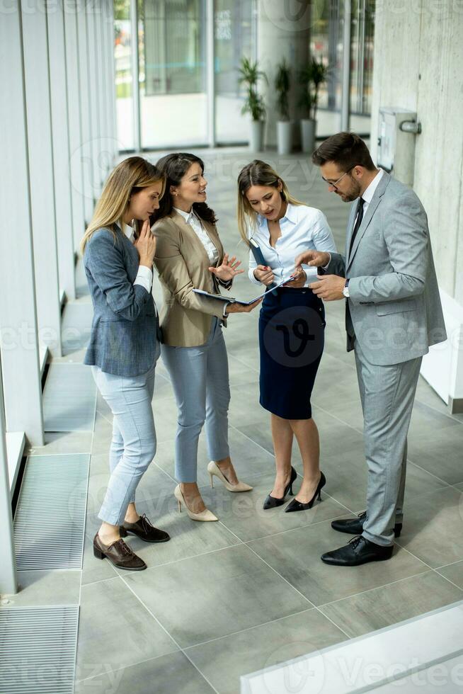 Young startup team have a discussion by stairs in the office corridor photo