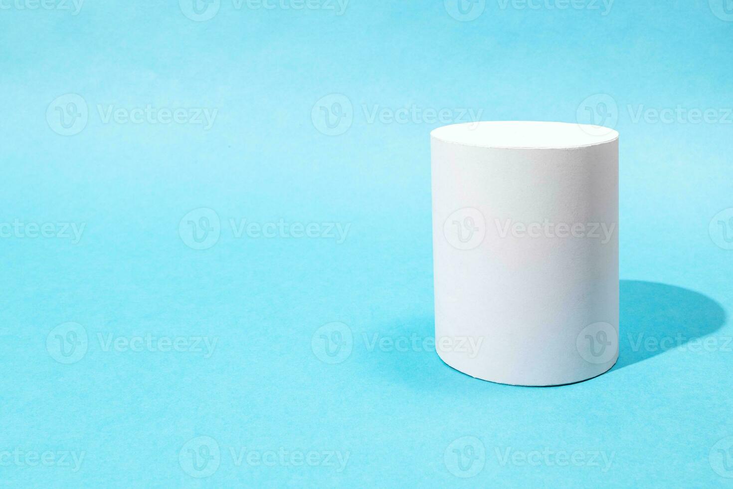 hand-crafted paper cylinder on turquoise blue photo