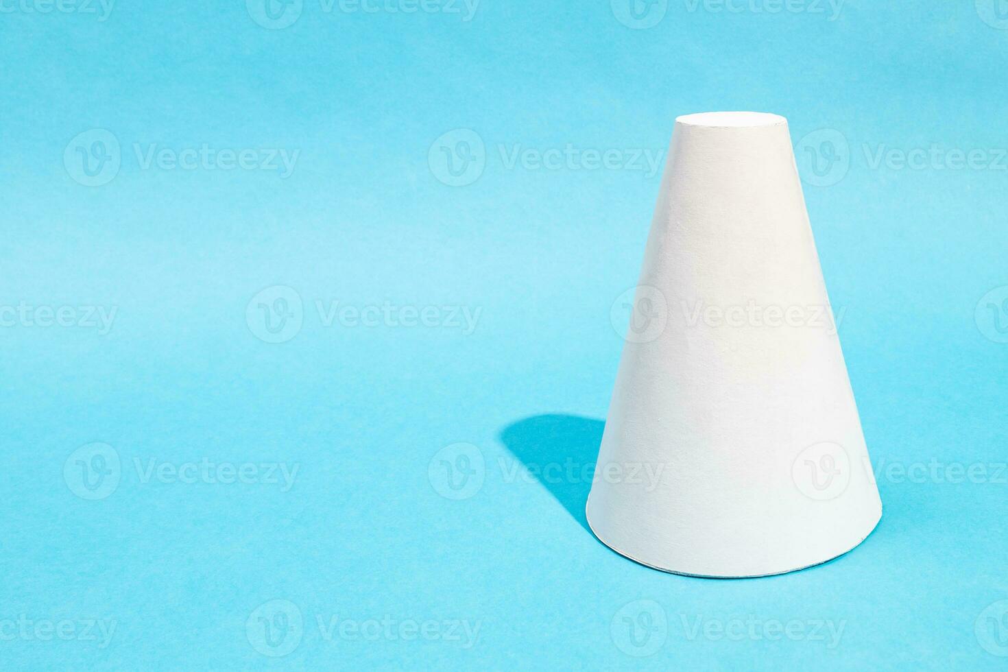 hand-crafted paper frustum cone on turquoise blue photo