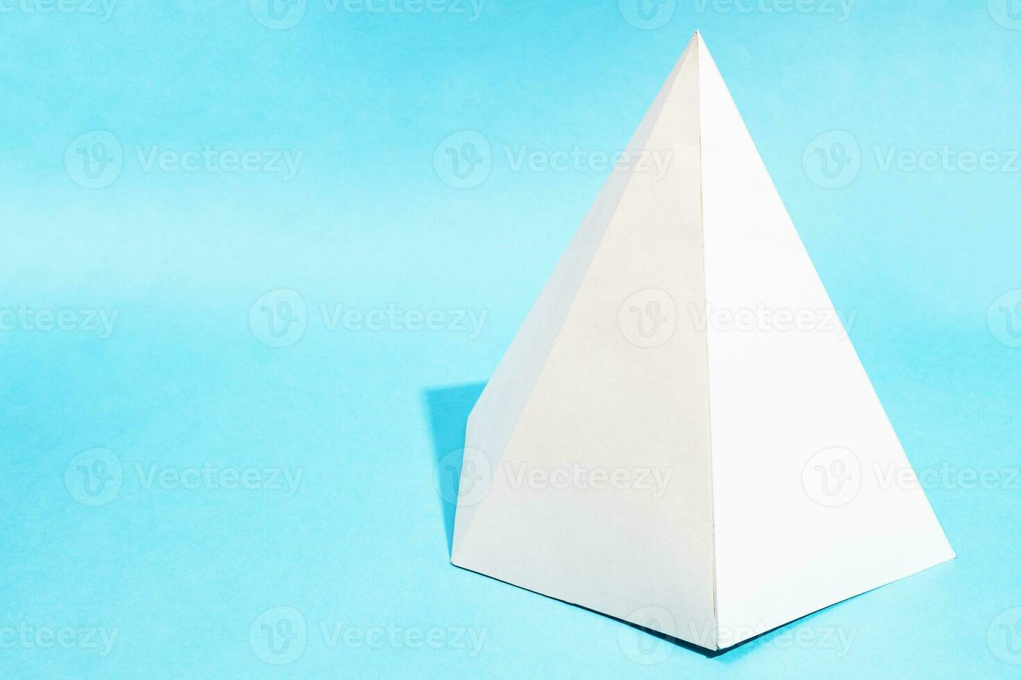 handcrafted paper hexagonal pyramid on turquoise photo
