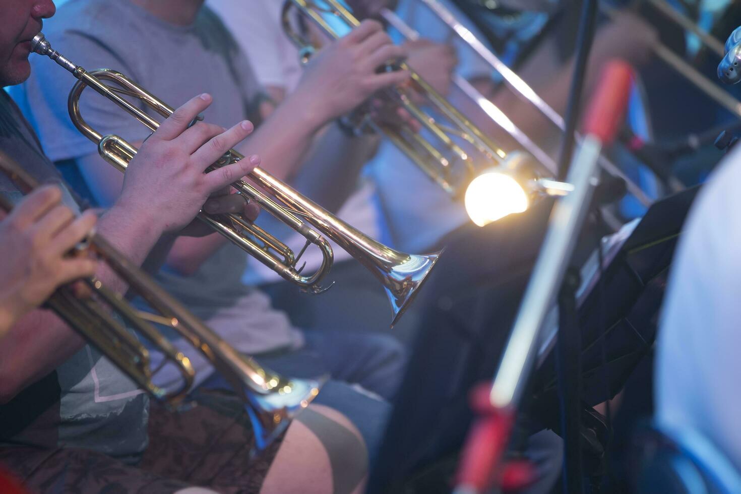 Belarus, the city of Gomel, June 25, 2021. Central office in the area.A group of musicians are playing on shiny trumpets. Musical symphony or jazz concert. photo