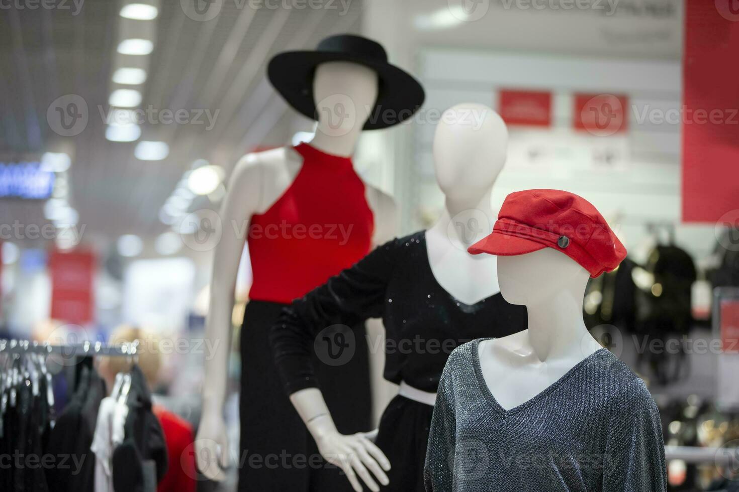 A group of mannequins in a store. Three women manikin in stylish clothes. Clothing sale concept. photo