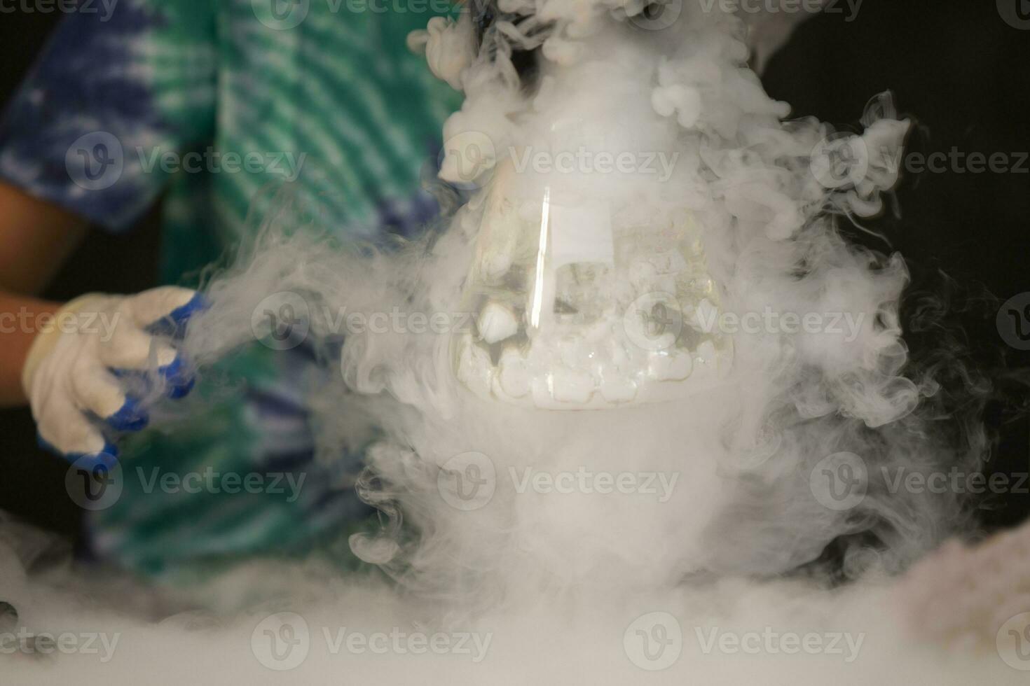 Glass flask with puffs of smoke as a result of liquid nitrogen reaction. photo